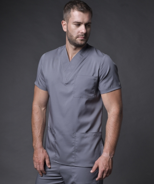 Hombre vistiendo scrub gris oscuro BIBE Medical volteando hacia el lado derecho - img optimizada